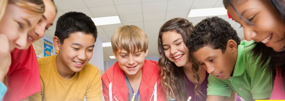 Teenagers laughing together in a classroom